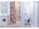 Bright bathroom featuring a floral shower curtain, modern vanity, and a separate toilet room at 2650 S Meridian St, Indianapolis, IN 46225
