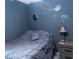 Dark bedroom with Star Wars themed décor and a comfortable gray bedspread at 2650 S Meridian St, Indianapolis, IN 46225