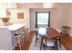 Dining area with a modern table set and a breakfast bar connecting to the kitchen at 2650 S Meridian St, Indianapolis, IN 46225