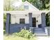 Charming bungalow featuring a covered front porch with gray brick supports and updated string lighting at 2650 S Meridian St, Indianapolis, IN 46225