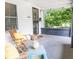 Charming porch with seating, a small blue table, and decor, enhancing the home's curb appeal at 2650 S Meridian St, Indianapolis, IN 46225
