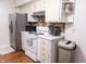 Kitchen features sleek stainless steel refrigerator and ample white cabinetry for storage at 2650 S Meridian St, Indianapolis, IN 46225