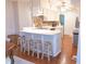 Open-concept kitchen boasts an island with breakfast bar seating, updated cabinets, and stainless steel appliances at 2650 S Meridian St, Indianapolis, IN 46225