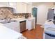Bright kitchen features stainless steel appliances, white countertops, and a stylish tile backsplash at 2650 S Meridian St, Indianapolis, IN 46225