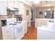 Well-lit kitchen showcasing ample white cabinetry, modern appliances, and durable hardwood flooring at 2650 S Meridian St, Indianapolis, IN 46225