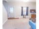 Bright living room featuring neutral carpet, stylish coffee table, and a view of the front door at 2650 S Meridian St, Indianapolis, IN 46225