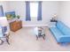 Bright living room with a comfy blue sofa, a modern TV, and a view of the front yard at 2650 S Meridian St, Indianapolis, IN 46225