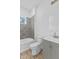 Bathroom with gray tiled shower/tub combo and gray vanity with white sink at 2709 Station St, Indianapolis, IN 46218