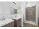Modern bathroom featuring double sinks, tiled shower, and contemporary fixtures at 2709 Station St, Indianapolis, IN 46218