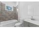 Bathroom with gray tiled shower/tub combo and gray vanity with white sink at 2709 Station St, Indianapolis, IN 46218