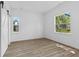 Bedroom with two windows, light wood look floors and a barn door at 2709 Station St, Indianapolis, IN 46218