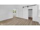 Bedroom with two doorways, a barn door and light wood look floors at 2709 Station St, Indianapolis, IN 46218