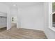 Spacious bedroom with hardwood floors, a walk-in closet, and an adjacent bathroom at 2709 Station St, Indianapolis, IN 46218