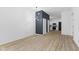 Open-concept dining area featuring a stylish light fixture, hardwood floors, and a view into the kitchen at 2709 Station St, Indianapolis, IN 46218