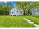 Charming single Gathering home with light siding, green yard, and a concrete walkway at 2709 Station St, Indianapolis, IN 46218