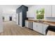 Spacious kitchen boasting white cabinets, stainless steel appliances, and hardwood floors leading to the living area at 2709 Station St, Indianapolis, IN 46218