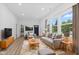 Bright living room with hardwood floors, modern furniture, and large windows offering a pleasant view at 2709 Station St, Indianapolis, IN 46218