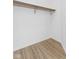 Walk-in closet with wood look floors and closet rod at 2709 Station St, Indianapolis, IN 46218