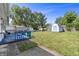 Spacious backyard featuring a blue deck, storage shed, and ample green space at 2829 Dakota Dr, Anderson, IN 46012