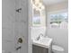 Contemporary bathroom featuring marble tile surround shower, modern lighting and brushed bronze fixtures at 2829 Dakota Dr, Anderson, IN 46012