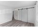 Bedroom showcasing luxury vinyl plank floors, sliding barn door closet and fresh white walls at 2829 Dakota Dr, Anderson, IN 46012