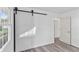 Bright room features a modern barn door, light vinyl floors and contemporary windows at 2829 Dakota Dr, Anderson, IN 46012