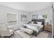 Bright bedroom with a Queen size bed, decorative lamps and art, chair and bench at 2829 Dakota Dr, Anderson, IN 46012