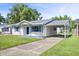 Inviting single-story home with a covered carport and well-kept front yard and driveway at 2829 Dakota Dr, Anderson, IN 46012
