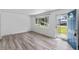 Bright living room with wood-look floors, neutral walls, and a large window at 2829 Dakota Dr, Anderson, IN 46012