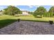 Backyard stone patio with view of treed and grassy yard at 3050 Montgomery Blvd, Lapel, IN 46051