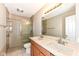 Well-lit bathroom with double sinks, granite countertops, and a tiled walk-in shower at 3050 Montgomery Blvd, Lapel, IN 46051
