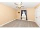 Bright bedroom with neutral carpet, ceiling fan, and natural light from the window at 3050 Montgomery Blvd, Lapel, IN 46051