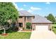 Charming two-story brick home with a well-manicured lawn and attached two car garage at 3050 Montgomery Blvd, Lapel, IN 46051
