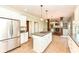 Open-concept kitchen with a center island and stainless steel refrigerator, adjacent to a cozy living room at 3050 Montgomery Blvd, Lapel, IN 46051