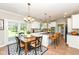 Bright kitchen with white cabinetry, island seating, and adjacent dining area at 3050 Montgomery Blvd, Lapel, IN 46051