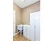 Practical laundry area with utility sink, storage cabinets, and neutral wall color at 3050 Montgomery Blvd, Lapel, IN 46051