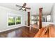 Bright living room with hardwood floors and view of the kitchen through decorative columns at 3050 Montgomery Blvd, Lapel, IN 46051