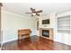 Cozy living room featuring a fireplace with built-in shelving and hardwood flooring at 3050 Montgomery Blvd, Lapel, IN 46051