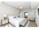 Spacious primary bedroom with a tray ceiling, fan, and ensuite bathroom entrance at 3050 Montgomery Blvd, Lapel, IN 46051