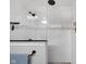 White tile shower with black shower head and glass door at 3101 N Washington Blvd, Indianapolis, IN 46205