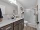 Well-lit bathroom features a dark wood vanity with a white sink and modern fixtures, with a glass shower stall at 3101 N Washington Blvd, Indianapolis, IN 46205