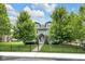 Beautiful gray home with black fence and lush green lawn and landscaping at 3101 N Washington Blvd, Indianapolis, IN 46205