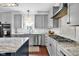 Kitchen featuring gray cabinets, stainless steel appliances, and granite countertops at 3101 N Washington Blvd, Indianapolis, IN 46205