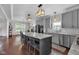 Open concept kitchen with large island, seating, gray cabinets, and stainless steel appliances at 3101 N Washington Blvd, Indianapolis, IN 46205
