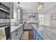 Bright kitchen with stainless appliances, granite countertops, and stylish gray and blue cabinetry at 3101 N Washington Blvd, Indianapolis, IN 46205
