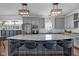 Kitchen with gray cabinets, stainless steel appliances, and a large island with a granite countertop at 3101 N Washington Blvd, Indianapolis, IN 46205