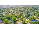 High-angle showcases a lush neighborhood with tree-covered properties and a serene, suburban setting at 319 S Webster Ave, Indianapolis, IN 46219