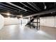 Expansive unfinished basement with exposed ceiling, concrete floors, and staircase at 319 S Webster Ave, Indianapolis, IN 46219