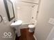 This bathroom offers a white pedestal sink, toilet, and shower with white subway tile surround at 319 S Webster Ave, Indianapolis, IN 46219
