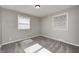 A serene bedroom with plush carpeting and two bright windows bringing in plenty of natural light at 319 S Webster Ave, Indianapolis, IN 46219